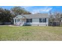 Traditional single-story home with black shutters and a cozy front porch at 3075 Old Highway 52, Moncks Corner, SC 29461