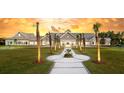 Stunning community clubhouse showcasing an amazing sunset and tropical palm trees at 332 Dahlia Row Dr, Summerville, SC 29486