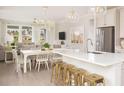 Bright, open kitchen with a white island, pendant lighting, and stainless steel appliances at 332 Dahlia Row Dr, Summerville, SC 29486