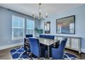 Elegant dining room featuring a chandelier, large windows, and a stylish sideboard at 3537 Sewel Ave, Mount Pleasant, SC 29466