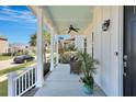Inviting front porch featuring a cozy seating area, ceiling fan, and pleasant outdoor ambiance at 3537 Sewel Ave, Mount Pleasant, SC 29466