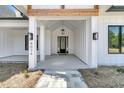 Welcoming entryway featuring a black front door and decorative lighting fixtures at 4036 Azalea Farms Way, McClellanville, SC 29458