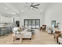 Bright, open-concept living room featuring modern furnishings and access to the kitchen at 4036 Azalea Farms Way, McClellanville, SC 29458