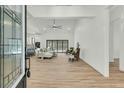 Spacious living room with hardwood floors, high ceilings, and natural light from the large sliding doors at 4036 Azalea Farms Way, McClellanville, SC 29458
