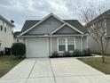 Beautiful single-Gathering home showcasing a driveway, garage, and manicured front yard at 4957 Trump St, North Charleston, SC 29420