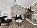 Stylish living room with brick accent wall, fireplace, and modern furnishings on hardwood floors at 5330 Waterview Dr, North Charleston, SC 29418