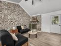 Cozy living room with a brick fireplace, comfortable seating, and ample natural light at 5330 Waterview Dr, North Charleston, SC 29418