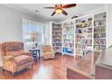 Cozy office with custom built-in bookshelves, hardwood flooring, and comfortable seating by a window at 5409 Clairmont Ln, North Charleston, SC 29420