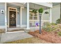 Inviting front porch with hanging flower baskets and decorative accents at 5415 Clairmont Ln, North Charleston, SC 29420