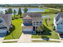 Aerial view of a landscaped home in a lakeside community with a private pond and outdoor seating at 543 Pendleton Dr, Moncks Corner, SC 29461