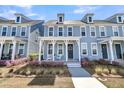 Attractive two-story townhouse with a covered porch and manicured front yard at 565 Blueway Ave, Summerville, SC 29486