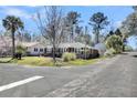 Brick home on a corner lot featuring a mature tree in the front yard with proximity to neighborhood street and sidewalks at 5921 Oak St, Hanahan, SC 29410