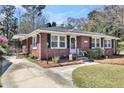 Classic brick home with black shutters, well-manicured lawn, and a welcoming entrance, reflecting traditional charm at 5921 Oak St, Hanahan, SC 29410