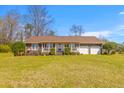 Charming single-story brick home with a well-manicured lawn and attached two-car garage at 729 2Nd Bend Rd, Harleyville, SC 29448