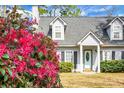 Charming two-story home with blooming shrubbery accenting the manicured front lawn at 8458 William Moultrie Dr, North Charleston, SC 29420