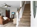 Cozy living room with staircase, comfortable seating, and natural light from the front door at 8458 William Moultrie Dr, North Charleston, SC 29420