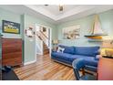 Cozy living room with nautical decor, wood-look floors, and stairs visible, creating a comfortable and stylish space at 103 Avalon Ct, Goose Creek, SC 29445