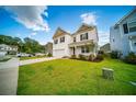Charming two-story home featuring a well-manicured lawn and a classic white exterior, perfect for suburban living at 107 Goose Rd, Summerville, SC 29483
