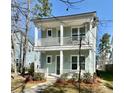 Charming two-story home with a double-porch, light blue siding, and landscaped front yard at 114 E Respite Ln, Summerville, SC 29483