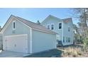 Exterior view of the home with a detached garage and light blue siding at 114 E Respite Ln, Summerville, SC 29483
