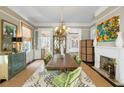 Elegant dining room with large table, chandelier, and fireplace at 115 Rutledge Ave # A, Charleston, SC 29401