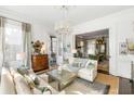 Bright living room featuring a decorative ceiling, chandelier and elegant decor at 115 Rutledge Ave # A, Charleston, SC 29401
