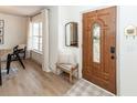 Cozy foyer with hardwood floors, a decorative mirror, and a beautifully crafted wooden front door at 122 Moon Shadow Ln, Summerville, SC 29485