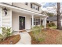 Inviting front porch with detailed columns and a view of the landscaped front yard at 122 Moon Shadow Ln, Summerville, SC 29485