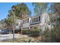 Inviting townhome with lush landscaping, complemented by a golf cart parked in the driveway at 1271 Island Club Dr # B, Charleston, SC 29492
