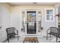 Inviting front porch featuring a stylish hello doormat, chairs, and potted plants for a welcoming entrance at 1271 Island Club Dr # B, Charleston, SC 29492