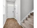 Clean entryway featuring hard wood floors with carpeted stairs leading up to the next level at 131 Horizon Ridge Dr, Summerville, SC 29486
