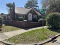 A classic brick house featuring a metal roof, complemented by well-maintained landscaping and a brick perimeter at 161 Gordon Street, Charleston, SC 29403