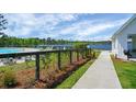 View of the community pool and lake from a walking path by the clubhouse at 169 Waccamaw Cir, Moncks Corner, SC 29461