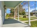 Cozy front porch with calming gray tones, providing a shaded retreat with a view of the quiet neighborhood at 2120 Thornlee Dr, North Charleston, SC 29405