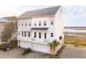 Charming coastal townhome with a private balconies, showcasing its unique architectural design and inviting curb appeal at 2135 Tides End Rd, Charleston, SC 29412