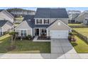 Charming home features a two-car garage, manicured lawn, and a cozy porch with lovely landscaping at 219 Daybreak Blvd, Summerville, SC 29486