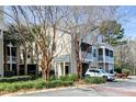 Exterior view of condo building featuring multiple stories, screened porch, and mature landscaping at 2434 Egret Crest Ln, Charleston, SC 29414