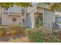 Charming townhome exterior with verdant shrubs and mature landscaping near the entrance at 2765 Jobee Dr # 1303, Charleston, SC 29414