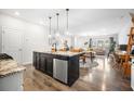 Bright, open kitchen featuring a granite island, stainless steel dishwasher, and adjacent dining and living area at 286 Godwit Dr, Summerville, SC 29486