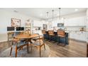 Open kitchen and dining area with island seating, stainless appliances, and an adjacent desk and workspace at 286 Godwit Dr, Summerville, SC 29486