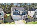 A bird's-eye view of a lovely house with a manicured yard and a driveway leading to a garage at 294 Torslanda Ln, Summerville, SC 29486