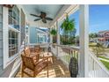 Inviting covered porch with comfortable seating, ceiling fan, and charming decorative lanterns at 312 Coki Amalie Ct, Charleston, SC 29492