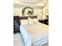 Comfortable bedroom with plush bedding, decorative artwork, and dark wood furniture at 330 Concord St # 11D, Charleston, SC 29401