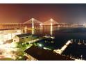 Illuminated bridge and waterfront buildings create an inviting night view on this waterfront property at 330 Concord St # 11D, Charleston, SC 29401