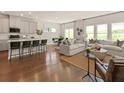 Bright living area featuring an open floor plan, hardwood floors, modern furnishings, and lots of natural light at 331 Calm Water Way, Summerville, SC 29486