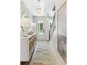 Inviting entryway with decorative wallpaper, stylish console table, and elegant lighting fixtures at 356 Claret Cup Way, Charleston, SC 29414