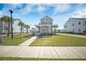 Charming two-story home boasting a welcoming front porch, well-manicured lawn, and inviting sidewalk entrance at 3785 Summerton St, Mount Pleasant, SC 29466