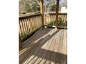 Sunny front porch with wooden decking and railing with space for outdoor seating at 391 Furman Ln, Ladson, SC 29456