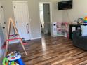 Spacious living room with hardwood floors, play kitchen and a view of the bathroom at 4800 Wheatfield Dr, Summerville, SC 29485