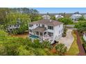 Aerial view of the home showcasing a covered patio, pool, spa, and large driveway at 4874 Sound View Dr, Mount Pleasant, SC 29466